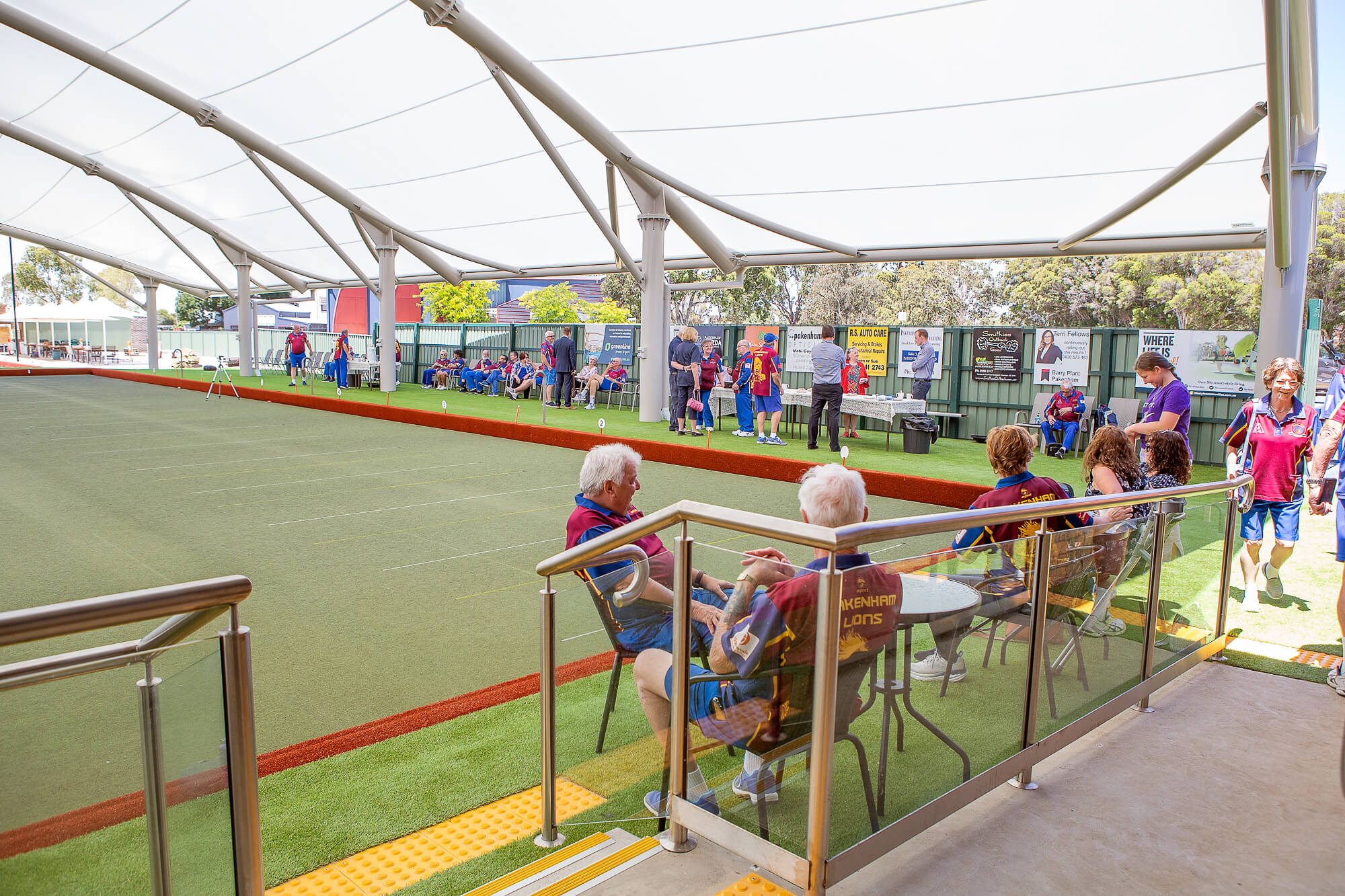 Members of Pakenham Bowling Club enjoying the shade under their new Bowling Green Roof