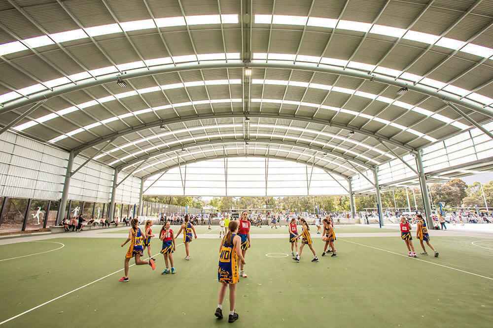 Curved roof structure over a sports court