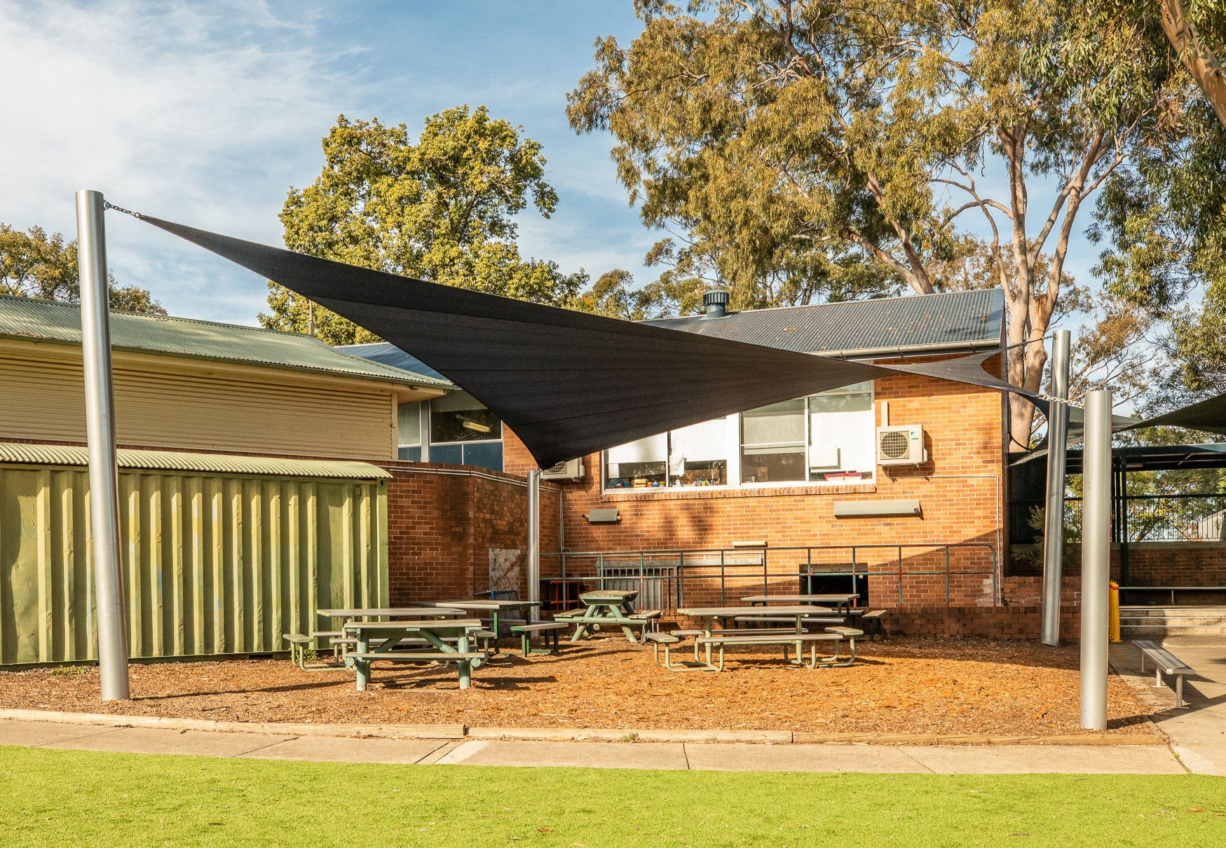 Waterproof shade sail installed in a backyard
