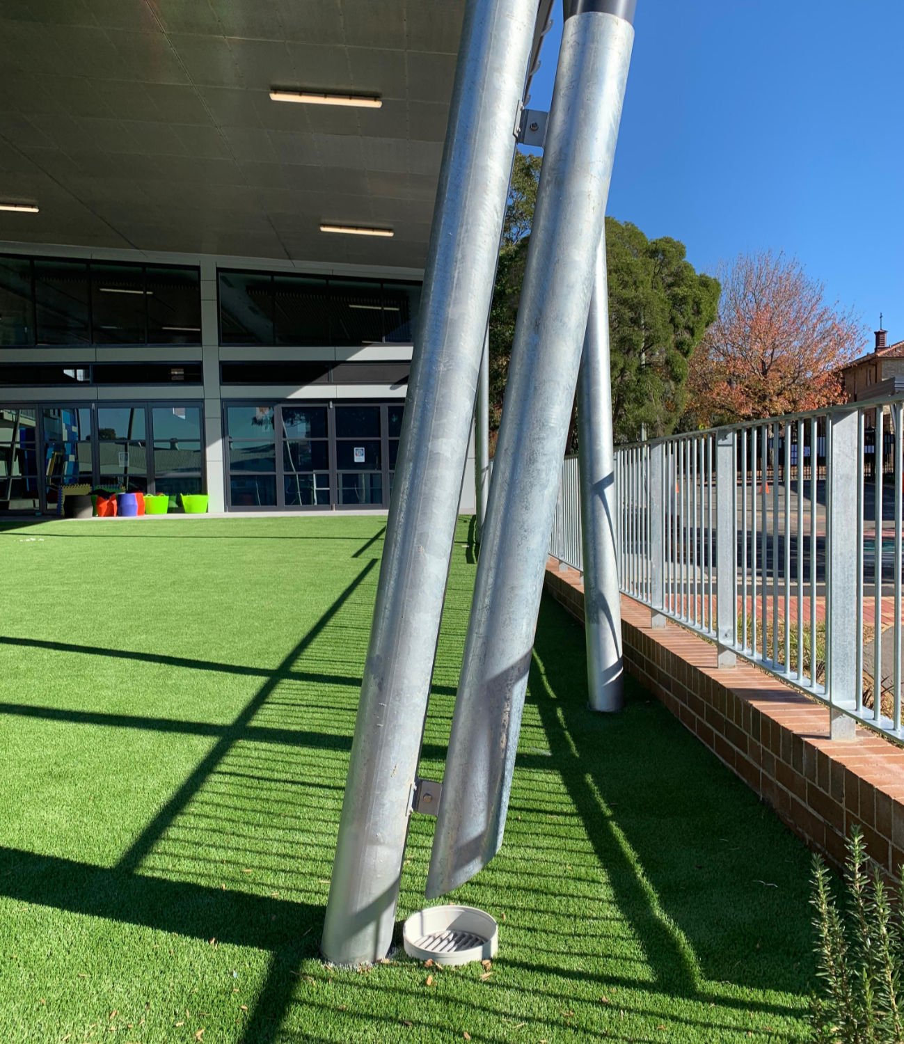 Galvanized steel pillars holding up a rigid shade structure